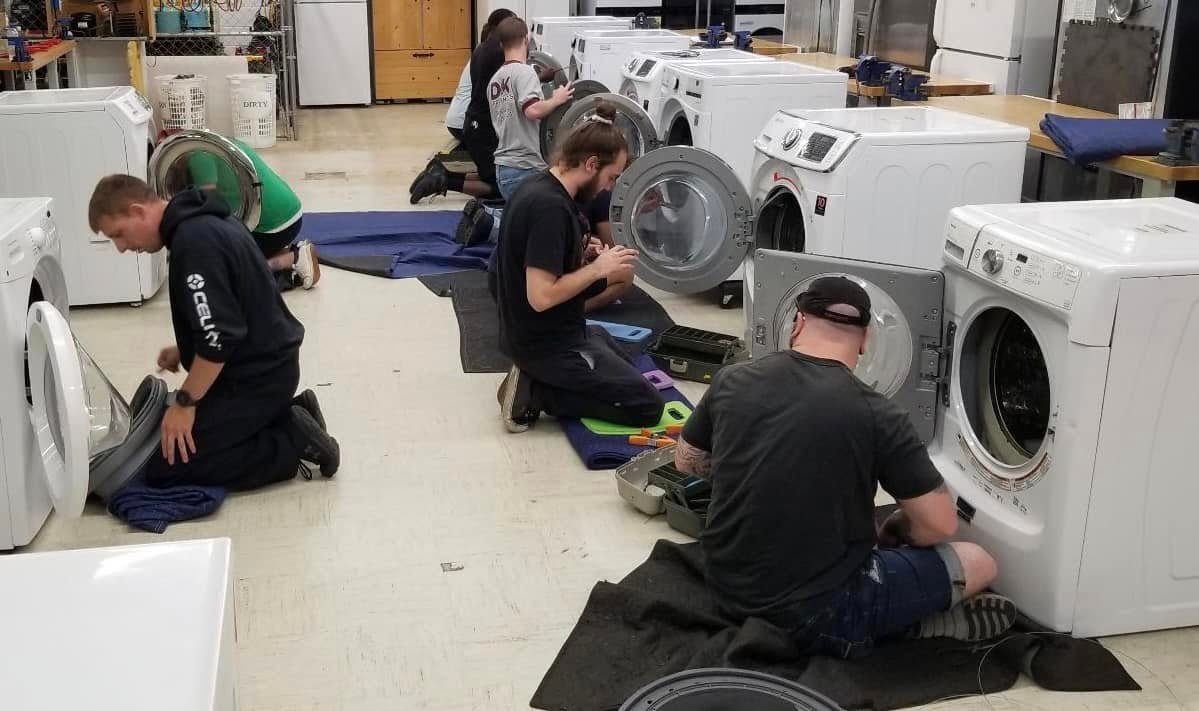 Elite Home Appliance Repair technician repairing a tumble dryer in Dubai