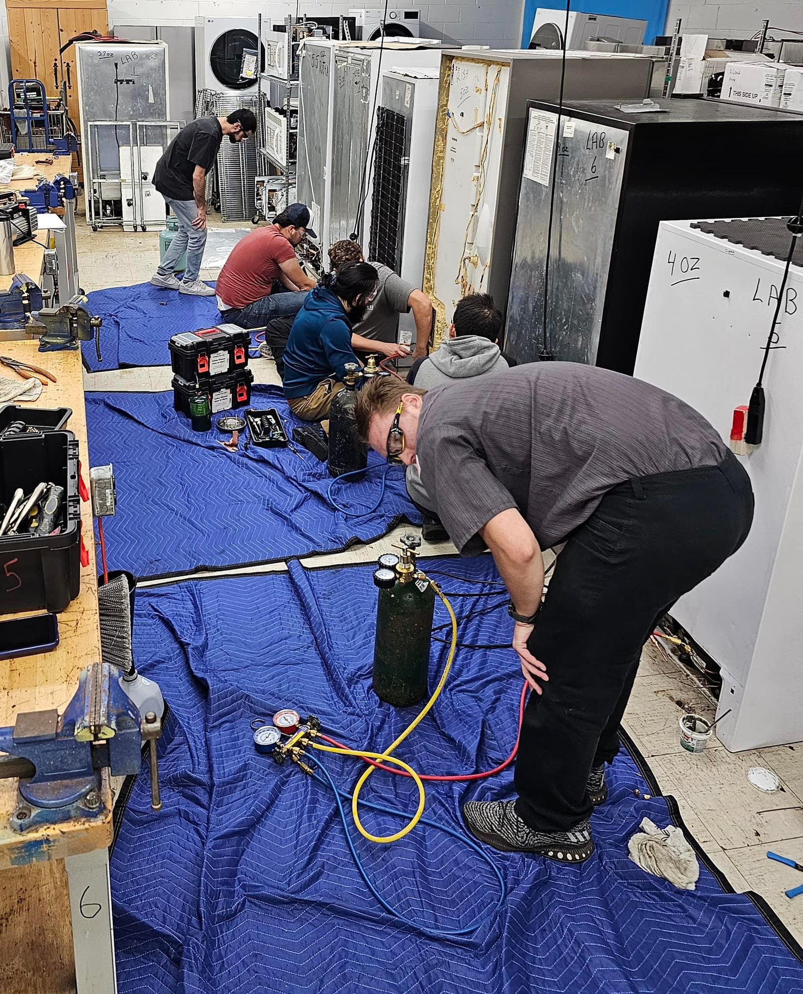 Elite Home Appliance Repair technician repairing a refrigerator in Dubai